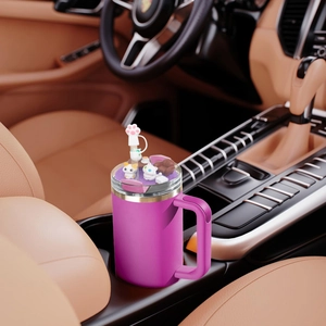 Pink 40oz tumbler with cat figurines and paw straw cover in car cup holder