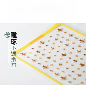 Detailed close-up of 5D embossed nail art stickers with bee and floral embroidery patterns