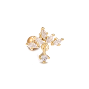 Macro shot of gold leaf-shaped stud earring with clear zircon dangles on white background