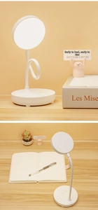 Close-up of white LED desk lamp showing flexible gooseneck and circular light head design