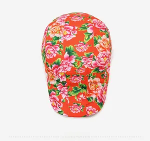 Top view of traditional floral print beret featuring red peony pattern and glossy fabric