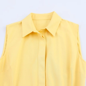 Yellow sleeveless shirt dress with a classic lapel collar and clean, minimalist texture