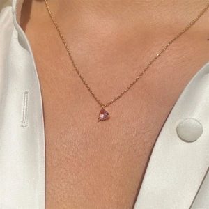 Detailed close-up of a pink heart-shaped zircon pendant on a 18k gold-plated chain