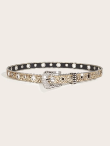 Detail of glitter belt with rhinestone buckle and silver metal grommets on gold surface