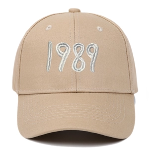 Close-up of premium khaki cotton baseball cap with 1989 embroidery detail and curved brim