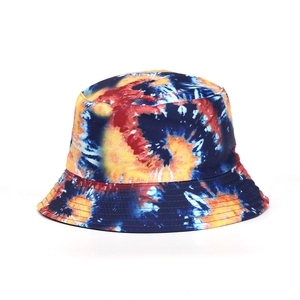 Detail shot of a vibrant tie-dye bucket hat with colorful blue, yellow, and orange patterns