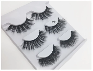 Macro shot of 5 pairs of thick black false eyelashes in a white tray model T01