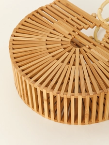 Macro shot of natural bamboo strips showing the detailed hollow-out weaving on this ark bag