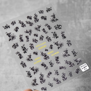 Detailed view of TOMONI vintage floral nail art stickers with elegant dark flower patterns
