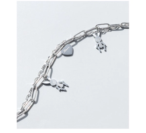 Detail of silver layered chain bracelet with rabbit pendants and heart Love charm