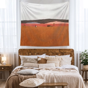 Detail of bohemian tapestry with abstract desert landscape above a wooden bed