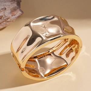 Polished gold wide cuff bracelet with fluid pleated metal texture and hinge closure