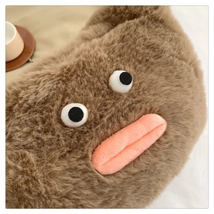 Detail of plush brown makeup bag with cute sausage lips and fuzzy texture