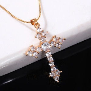 Elegant gold cross pendant necklace with sparkling crystal zircon stones on a thin chain