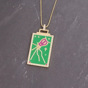 Golden square necklace featuring green and magenta enamel squid with star details