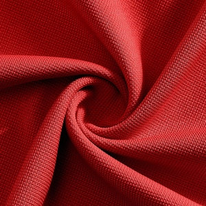 Macro shot of red hexagonal mesh knit fabric texture for men's polo shirts