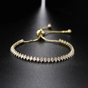 Macro detail of adjustable gold tennis bracelet featuring marquise-cut cubic zirconia