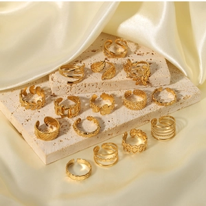 Detailed close-up of 18k gold plated stainless steel rings with floral and leaf designs