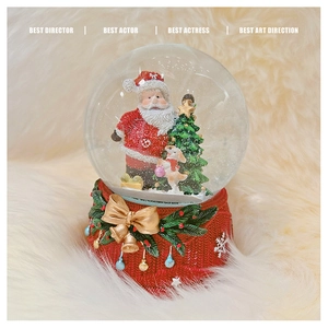 Detail of Christmas snow globe featuring Santa, tree, and festive red knitted base