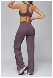 Back view of a purple yoga set featuring a racerback sports bra and high-waisted wide-leg pants