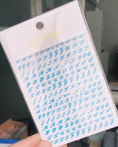 Detailed view of blue cursive letter nail stickers WG720 in 3D design packaging