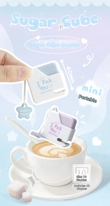 Miniature blue and purple sugar cube staplers shown in hand for scale and size detail