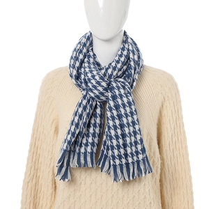 Blue and white houndstooth cashmere-like scarf with fringe on a mannequin