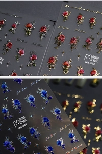 Close-up of vintage rose nail stickers with detailed gold edges and relief texture