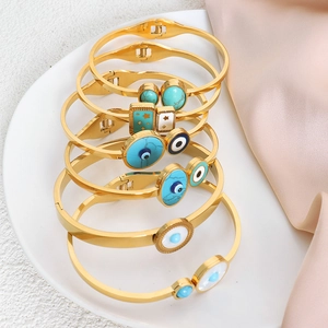 Set of 6 gold stainless steel Evil Eye bracelets featuring blue enamel and star charms