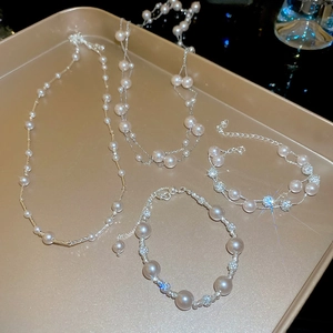 Detail of elegant pearl necklaces and bracelets set in a champagne gold tray