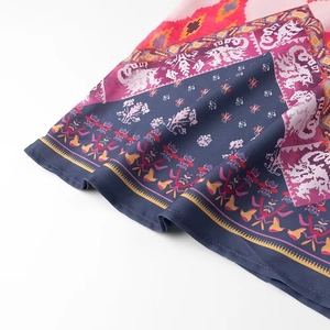 Close-up of lightweight ethnic print fabric with vibrant bohemian floral patterns