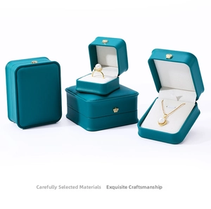 Macro detail of teal PU leather jewelry box set featuring gold crown metal clasps