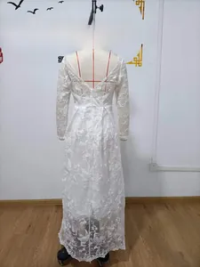 Detail of white lace long sleeve wedding dress showing elegant deep V-cut back design