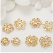 Close-up of DIY gold hollow flower bead caps and jewelry findings for pearl earrings