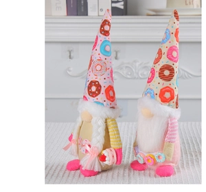 Close-up of fabric Christmas gnomes with donut patterns and soft plush details