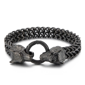 Rugged gun-black stainless steel bracelet featuring dual wolf heads and woven chain