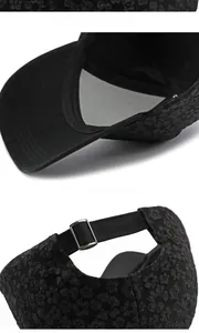 Detail of black floral baseball cap showing 3D flower texture and metal back buckle