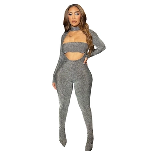 Detail of silver sequined bodysuit with high neck and sexy cutout design in metallic fabric