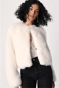 Detail of premium white faux fur texture on a cropped collarless autumn jacket