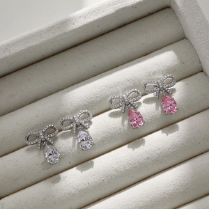 Detail of S925 silver bow earrings with pear-cut zircon drops in a jewelry box
