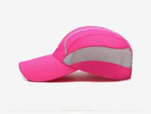 Detail of rose red sports cap showing grey breathable mesh and reflective side strips