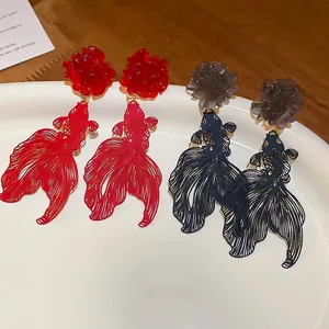 Silver needle resin flower earrings with hollow koi fish pendants in red and blue