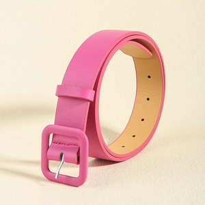 Close-up of pink leather belt with square buckle and premium pebble grain texture