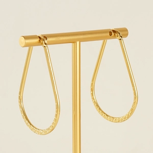 Close-up of French vintage textured water drop earrings with 18K gold plated finish