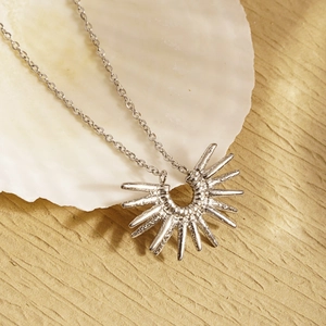 Silver stainless steel sunburst pendant necklace with a geometric sun flower design