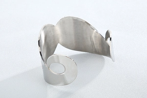 Detailed side view showing the brushed silver finish and hollowed-out curve of the cuff bracelet