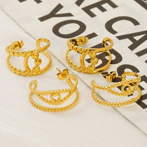 Chic double-layered geometric gold hoop earrings with beaded texture on vintage newspaper