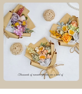 Flat lay of three silk rose bouquets in purple, orange and peach with kraft paper wrap
