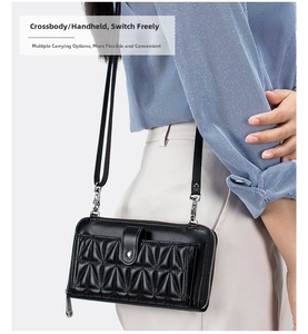 Detail of black quilted leather crossbody phone bag with metal hardware and strap