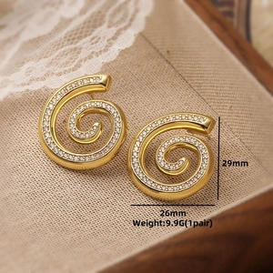Detail view of gold spiral earrings with white zircons showing dimensions 29mm and 26mm
